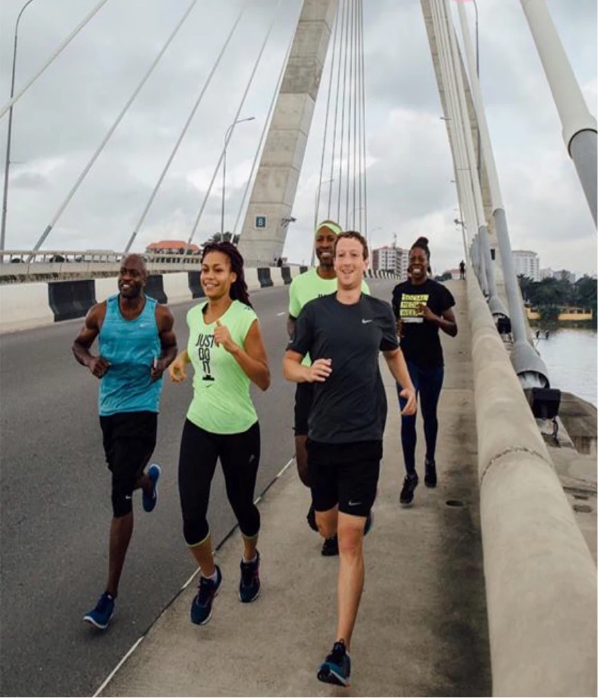 Dayo running with Mark Zuckerberg and others across a bridge in Lagos