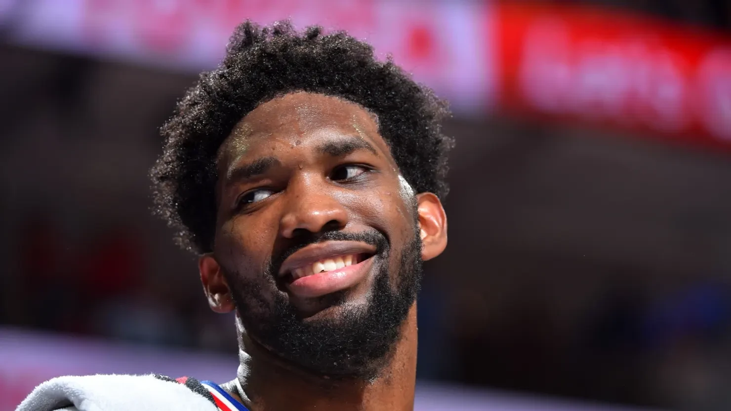 Joel Embiid of the Philadelphia 76ers, smiling on court