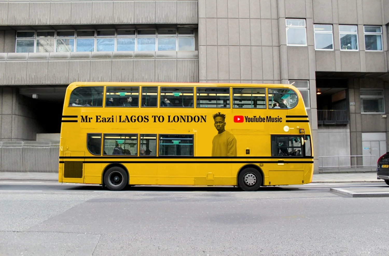 A London double-decker bus wrapped in a yellow YouTube Music ad for Mr Eazi&rsquo;s Lagos to London